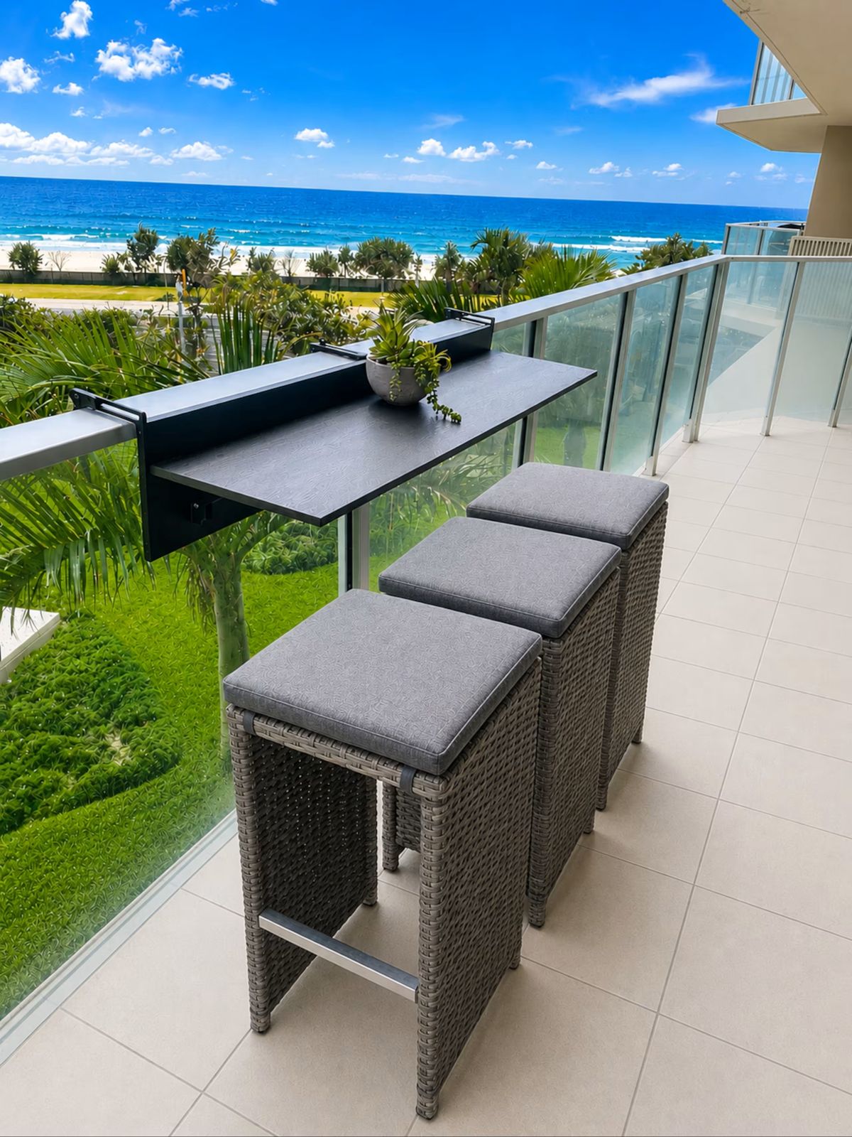 Balcony with bar table and stools overlooking the beach and ocean, Surfers Paradise